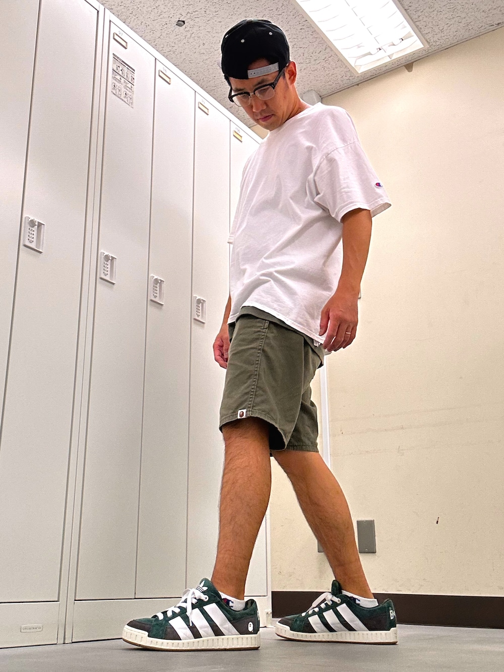 ホワイト系のTシャツ/カットソー、グリーン系のチノパンツ、グリーン系のスニーカーを着用したメンズの秋コーディネートの2枚目の写真