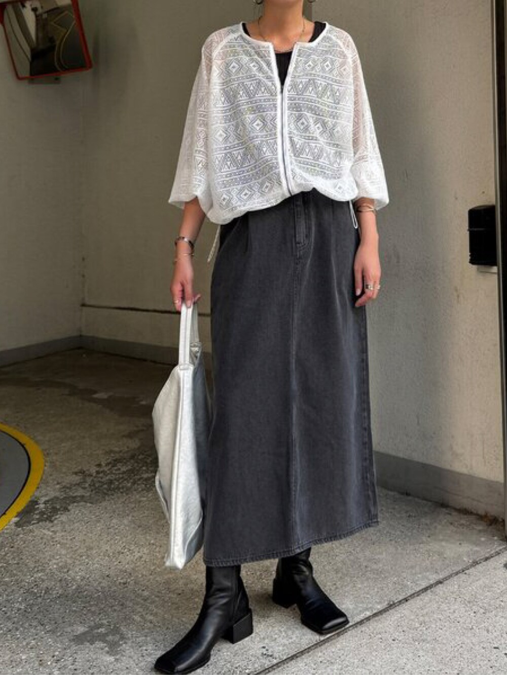 ブラック系のブルゾン、グリーン系のスカートを着用したレディースの夏コーディネートの2枚目の写真