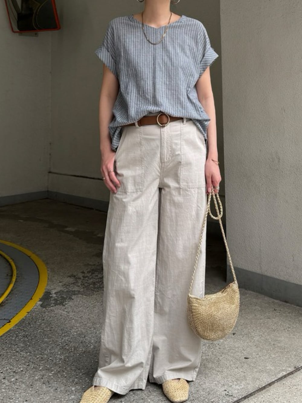 ホワイト系のシャツ/ブラウス、ベージュ系のトートバッグ、ブルー系のパンツを着用したレディースの夏コーディネートの3枚目の写真