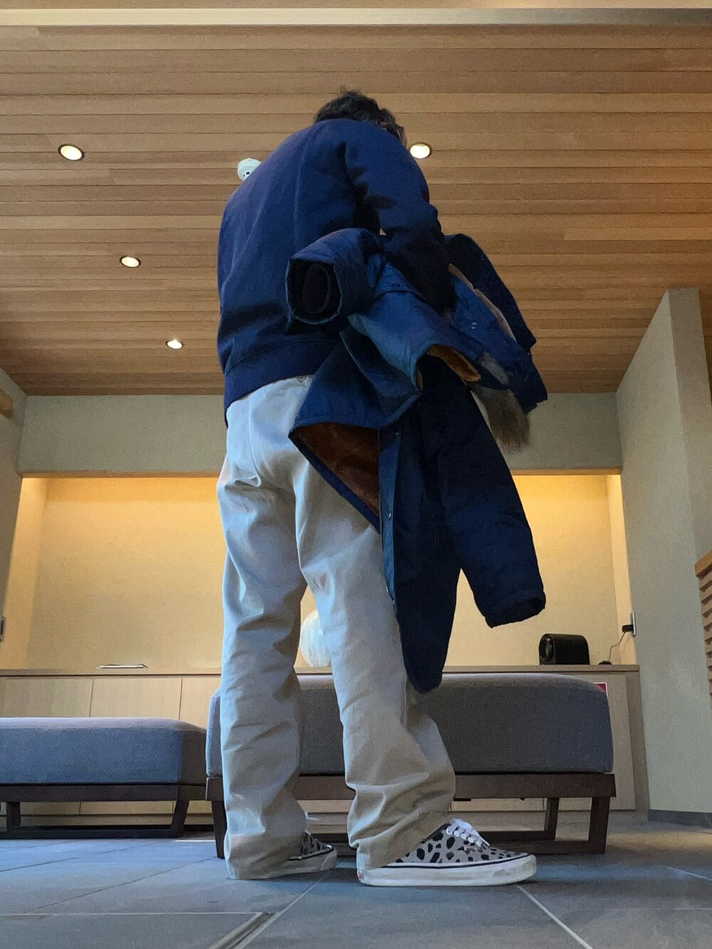 ベージュ系のチノパンツ、ブルー系のスウェット、グレー系のスニーカーを着用したメンズの冬コーディネートの2枚目の写真