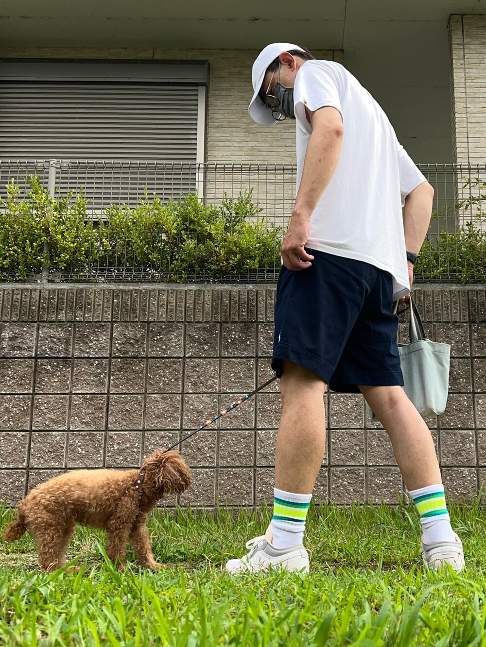ホワイト系のTシャツ/カットソー、ブルー系のチノパンツ、ホワイト系のスニーカーを着用したメンズの夏コーディネートの2枚目の写真