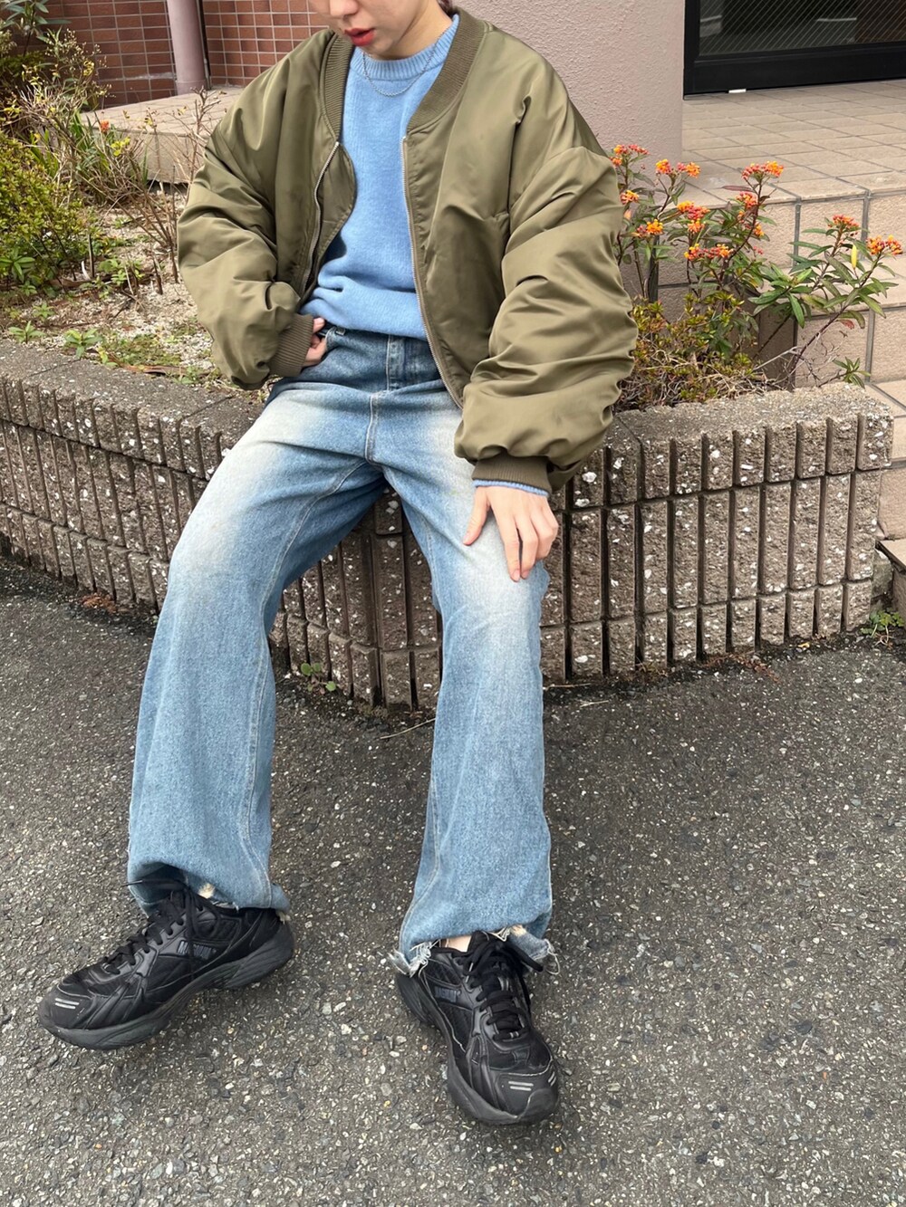 ブルー系のデニムパンツ、ブラック系のシューズ、グリーン系のジャケット/アウターを着用したレディースの冬コーディネートの2枚目の写真