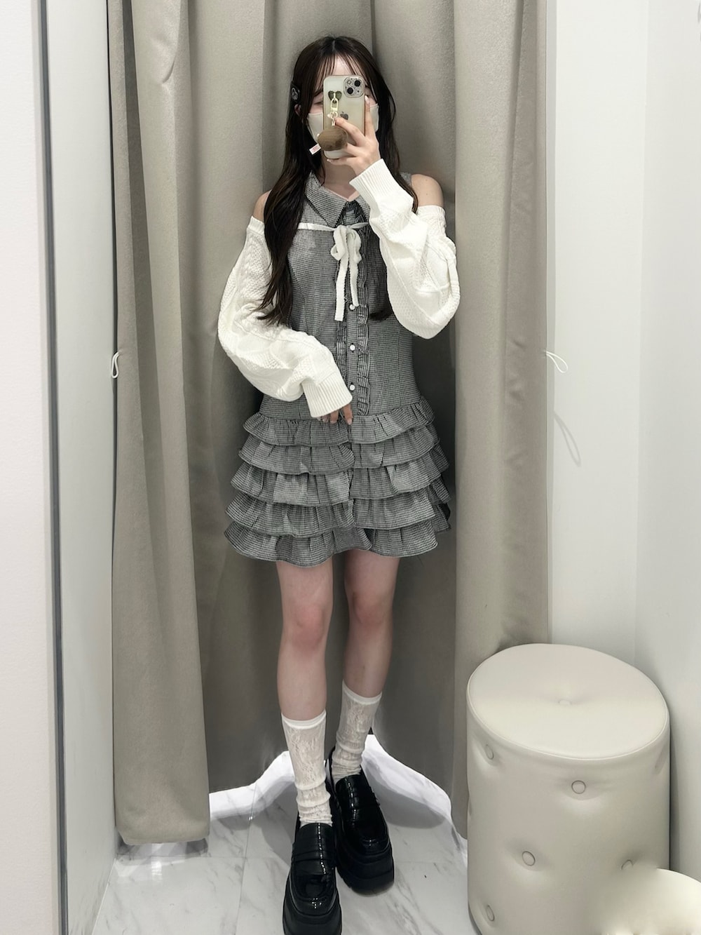 ブラック系のワンピース、ホワイト系のカーディガン/ボレロ、ブラック系のローファーを着用したレディースの春コーディネートの4枚目の写真