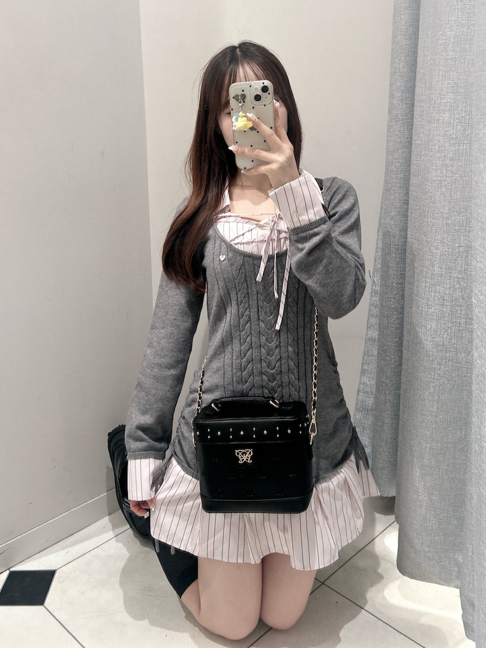 グレー系のワンピース、ブラック系のショルダーバッグを着用したレディースの秋コーディネートの7枚目の写真