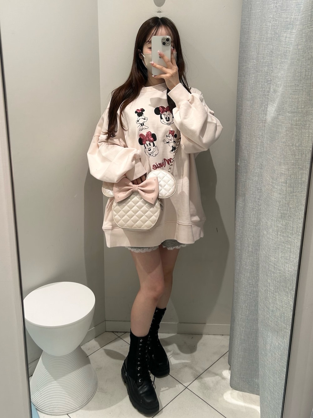 ピンク系のスウェット、ピンク系のショルダーバッグを着用したレディースの冬コーディネートの4枚目の写真