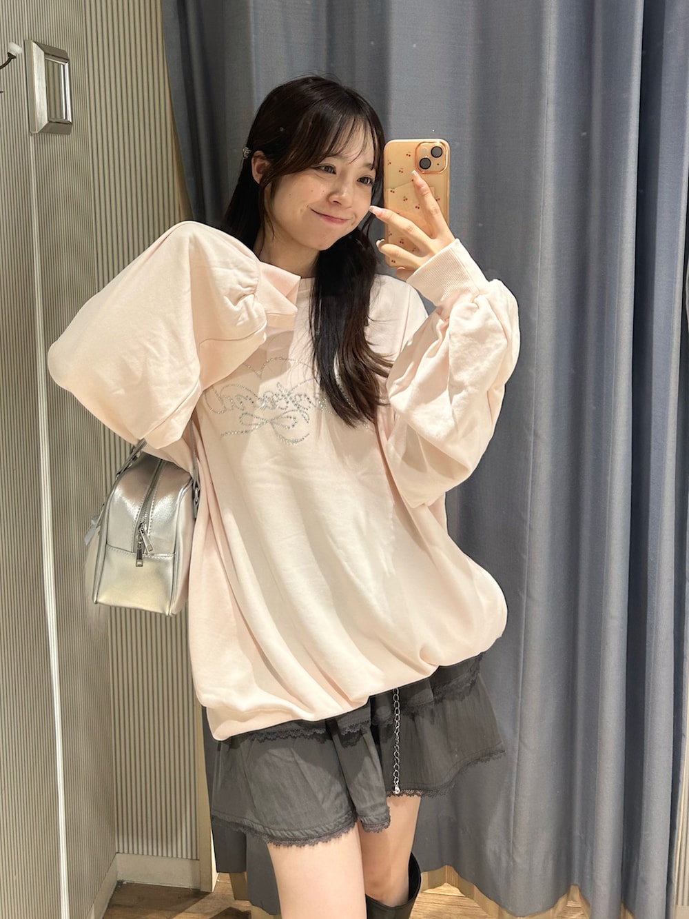 ピンク系のTシャツ/カットソー、グレー系のスカート、シルバー系のショルダーバッグを着用したレディースの秋コーディネートの3枚目の写真