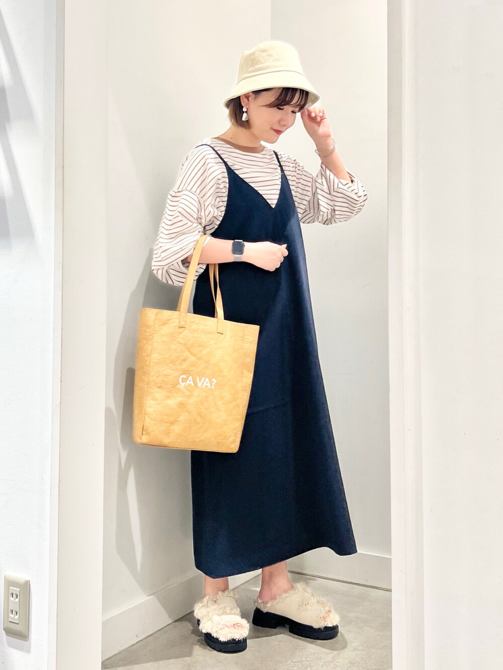 ブルー系のワンピース、ベージュ系のトートバッグ、ベージュ系のサンダルを着用したレディースの夏コーディネートの3枚目の写真