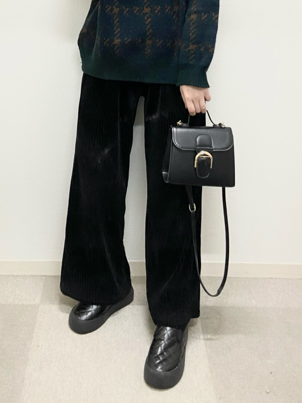 グリーン系のニット/セーター、ブラック系のスニーカーを着用したレディースの冬コーディネートの3枚目の写真