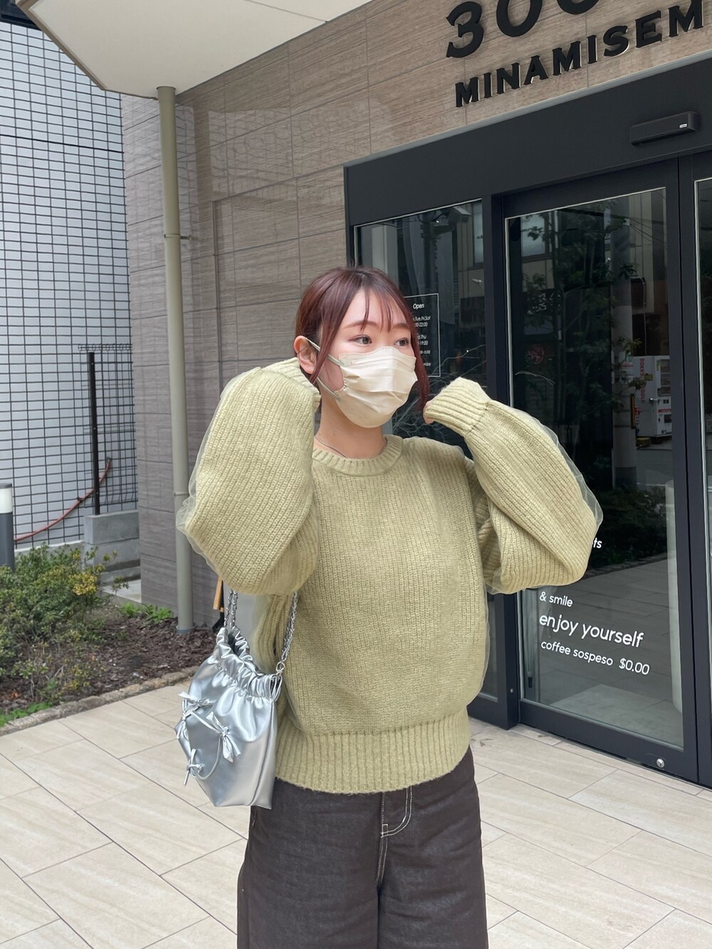 グリーン系のニット/セーターを着用したレディースの春コーディネートの6枚目の写真