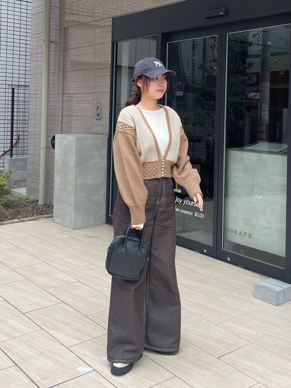 ベージュ系のニット/セーター、ホワイト系のTシャツ/カットソーを着用したレディースの春コーディネートの2枚目の写真