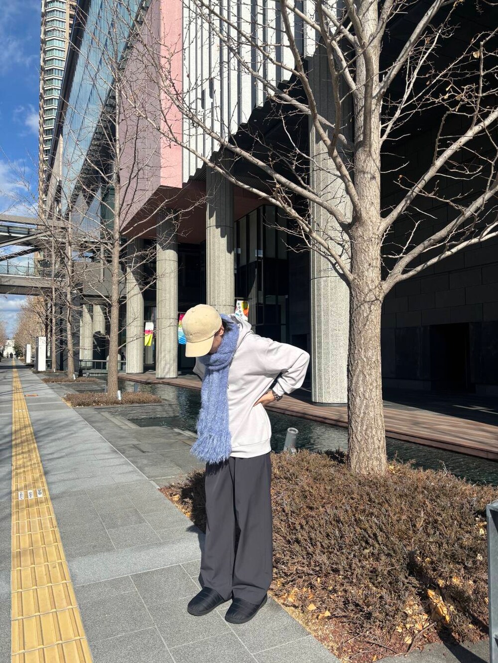 グレー系のパーカー、グレー系のその他パンツ、ベージュ系のキャップを着用したメンズの冬コーディネートの4枚目の写真