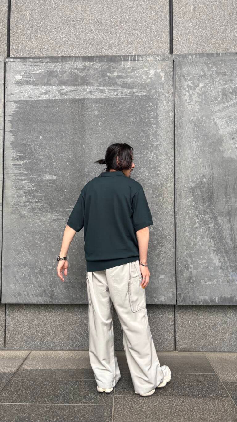 グリーン系のニット/セーター、グレー系のその他パンツを着用したメンズの春コーディネートの6枚目の写真