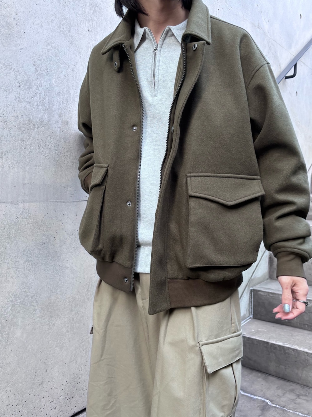 グレー系のニット/セーター、ブラウン系のブルゾン、ベージュ系のその他パンツを着用したメンズの冬コーディネートの3枚目の写真