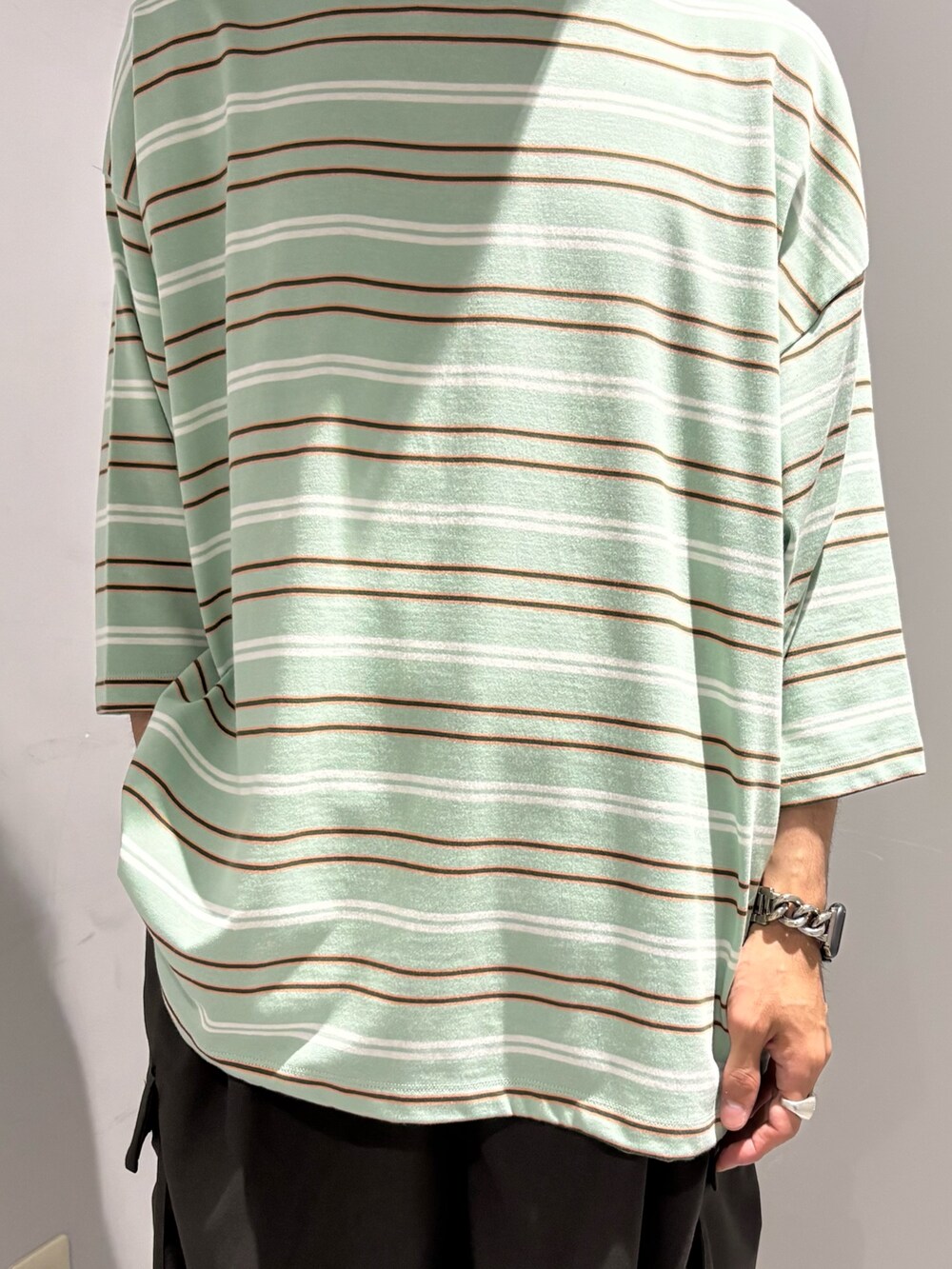 グレー系のその他パンツ、グリーン系のTシャツ/カットソーを着用したメンズの夏コーディネートの2枚目の写真