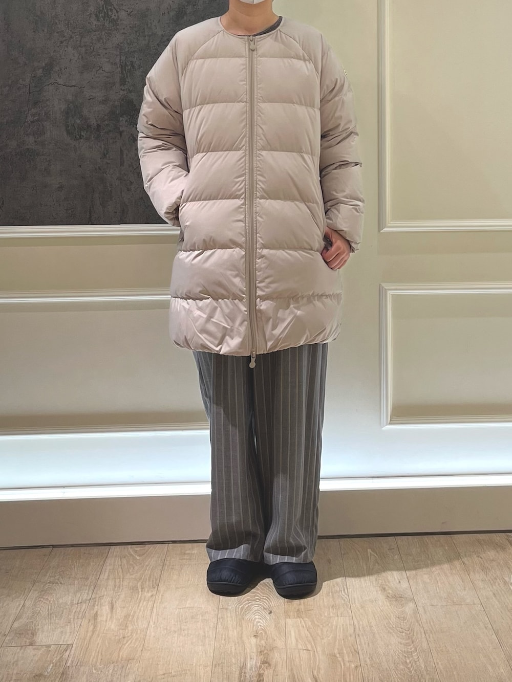 ブラック系のサンダル、ベージュ系のダウンジャケット/コート、ブラック系のその他パンツを着用したレディースの秋コーディネートの2枚目の写真