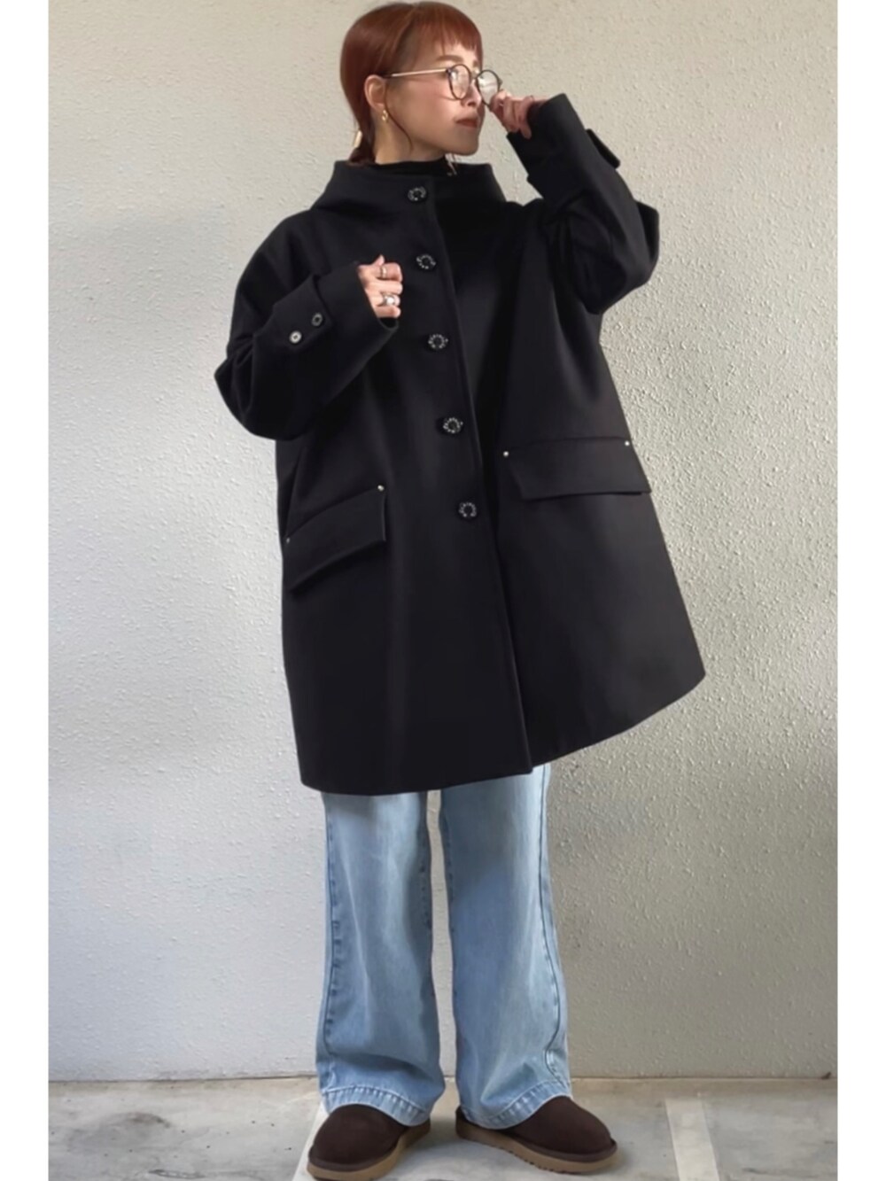 ブラック系のその他アウター、ブルー系のデニムパンツ、その他のシューズを着用したレディースの冬コーディネートの2枚目の写真