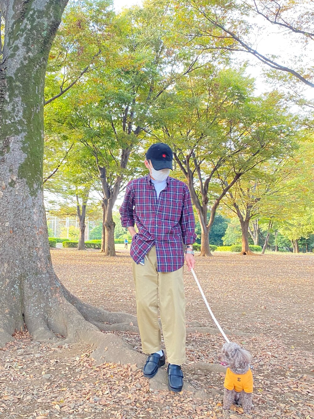 レッド系のシャツ/ブラウス、ホワイト系のTシャツ/カットソー、ベージュ系のチノパンツを着用したメンズの秋コーディネートの5枚目の写真