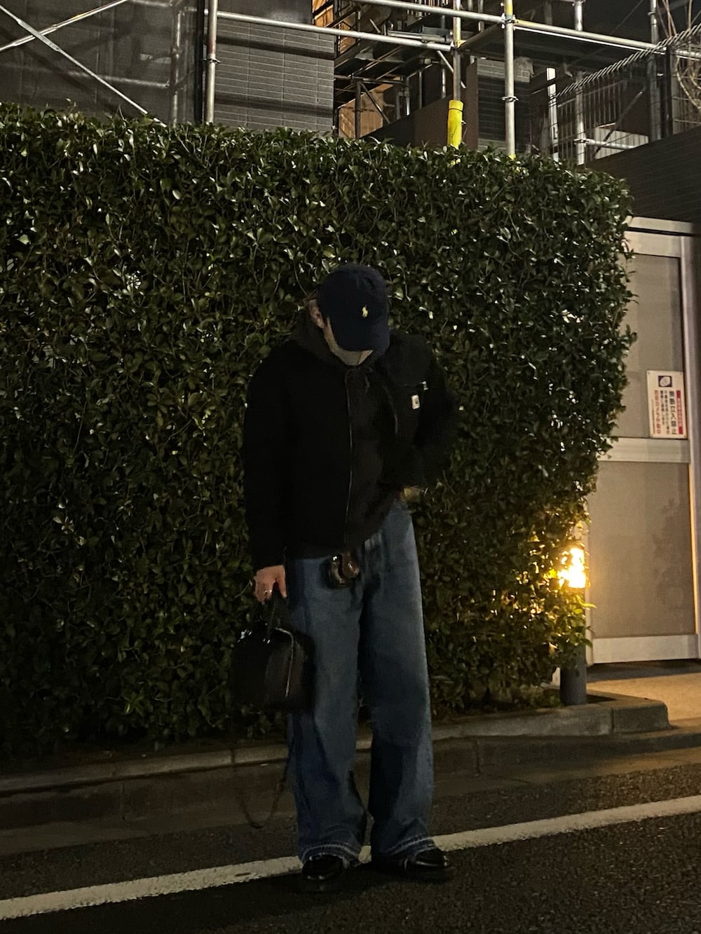 ブラック系のその他アウター、グレー系のパーカー、ブルー系のデニムパンツを着用したメンズの春コーディネートの3枚目の写真