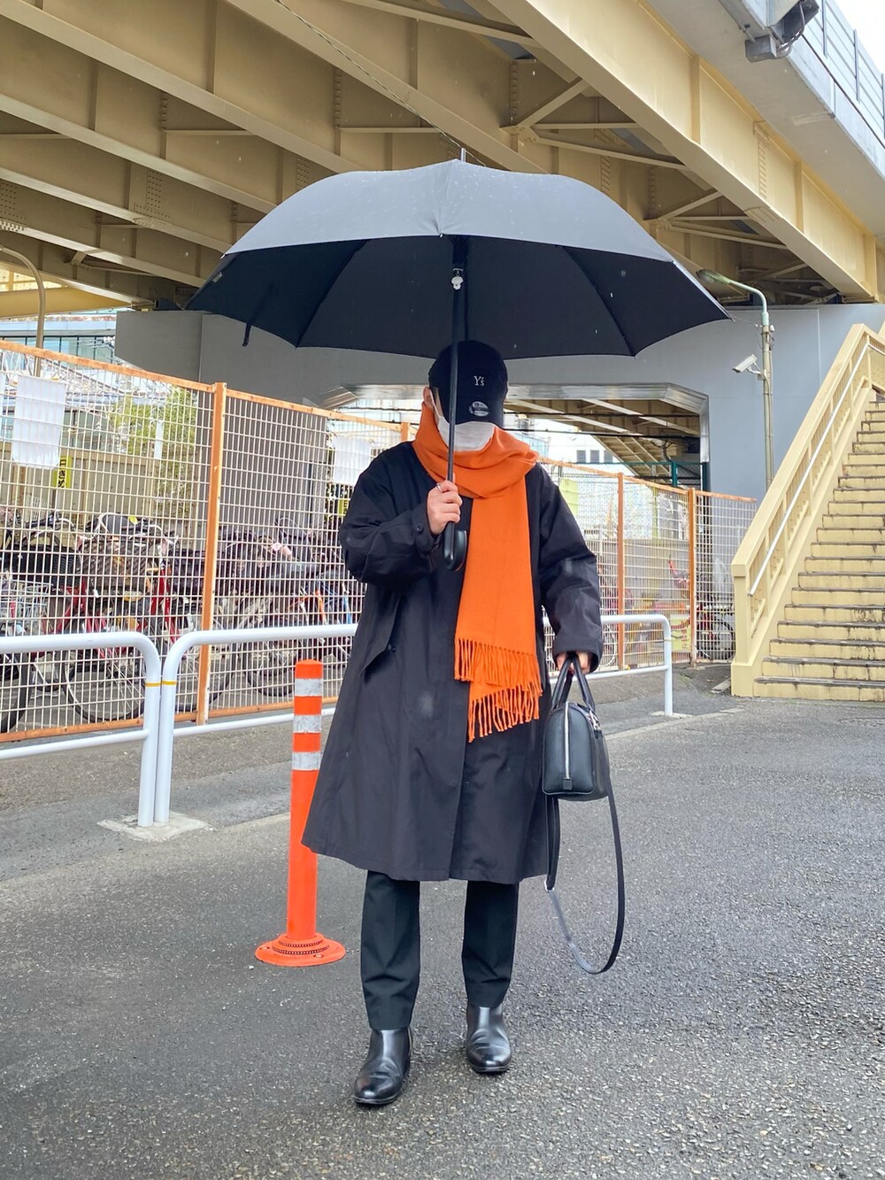 ブラック系のモッズコート、ブラウン系のカーディガン/ボレロ、ホワイト系のTシャツ/カットソーを着用したメンズの春コーディネートの3枚目の写真