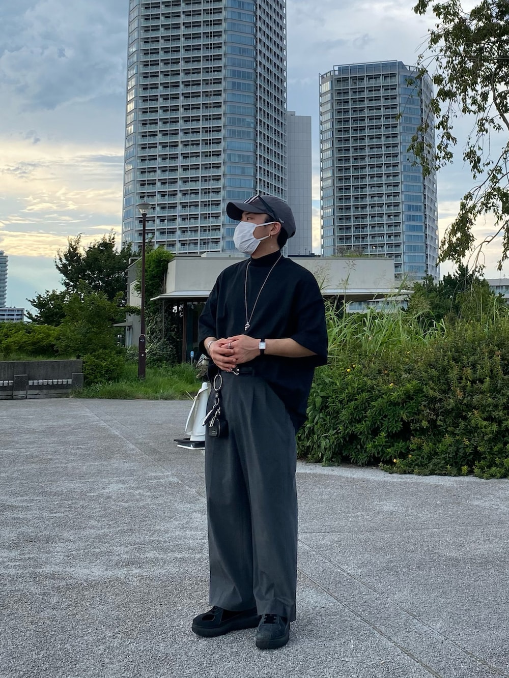 ブラック系のTシャツ/カットソー、グレー系のパンツ、ブラック系のスニーカーを着用したメンズの夏コーディネートの3枚目の写真