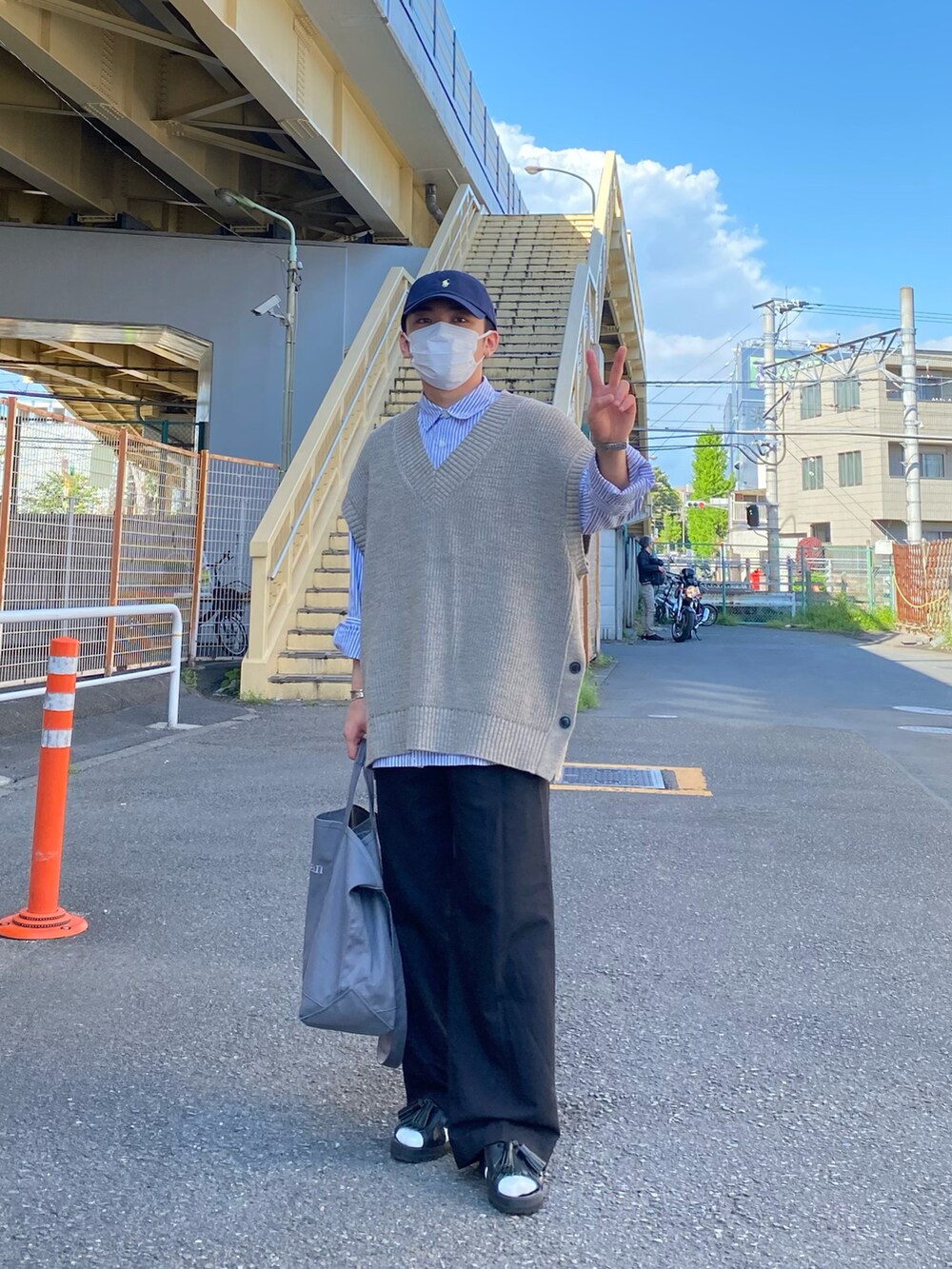 ベージュ系のベスト、ブルー系のシャツ/ブラウス、ブラック系のパンツを着用したメンズの春コーディネートの5枚目の写真