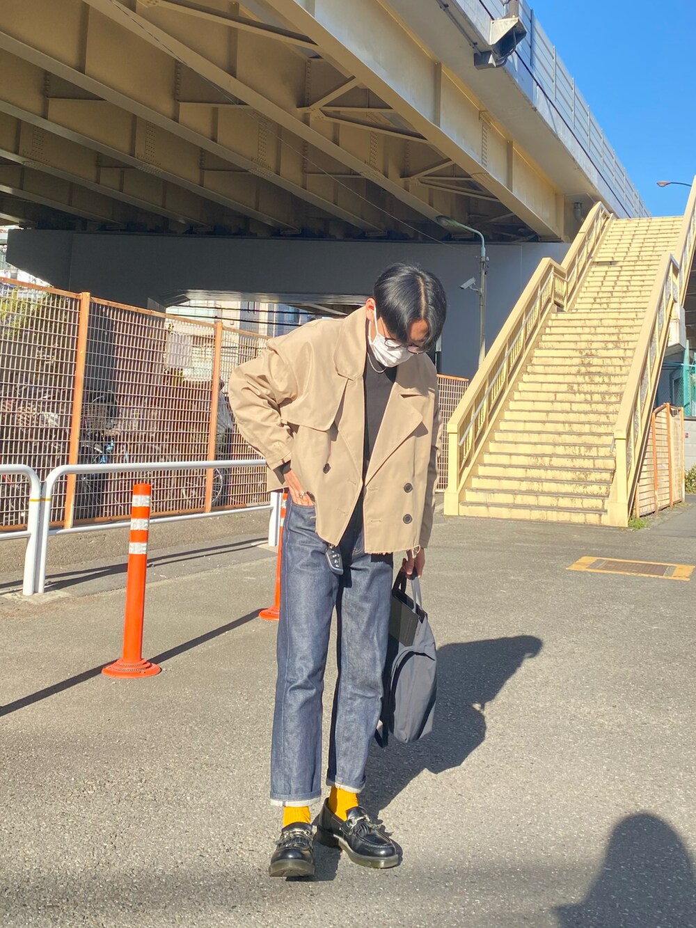 ベージュ系のブルゾン、ブラック系のスウェット、ブルー系のデニムパンツを着用したメンズの冬コーディネートの4枚目の写真