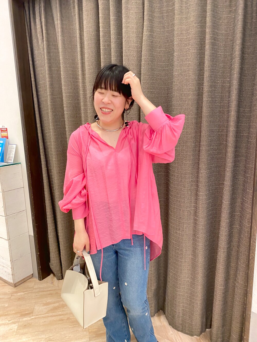 ピンク系のシャツ/ブラウス、ホワイト系のトートバッグ、ブルー系のデニムパンツを着用したレディースの夏コーディネートの2枚目の写真