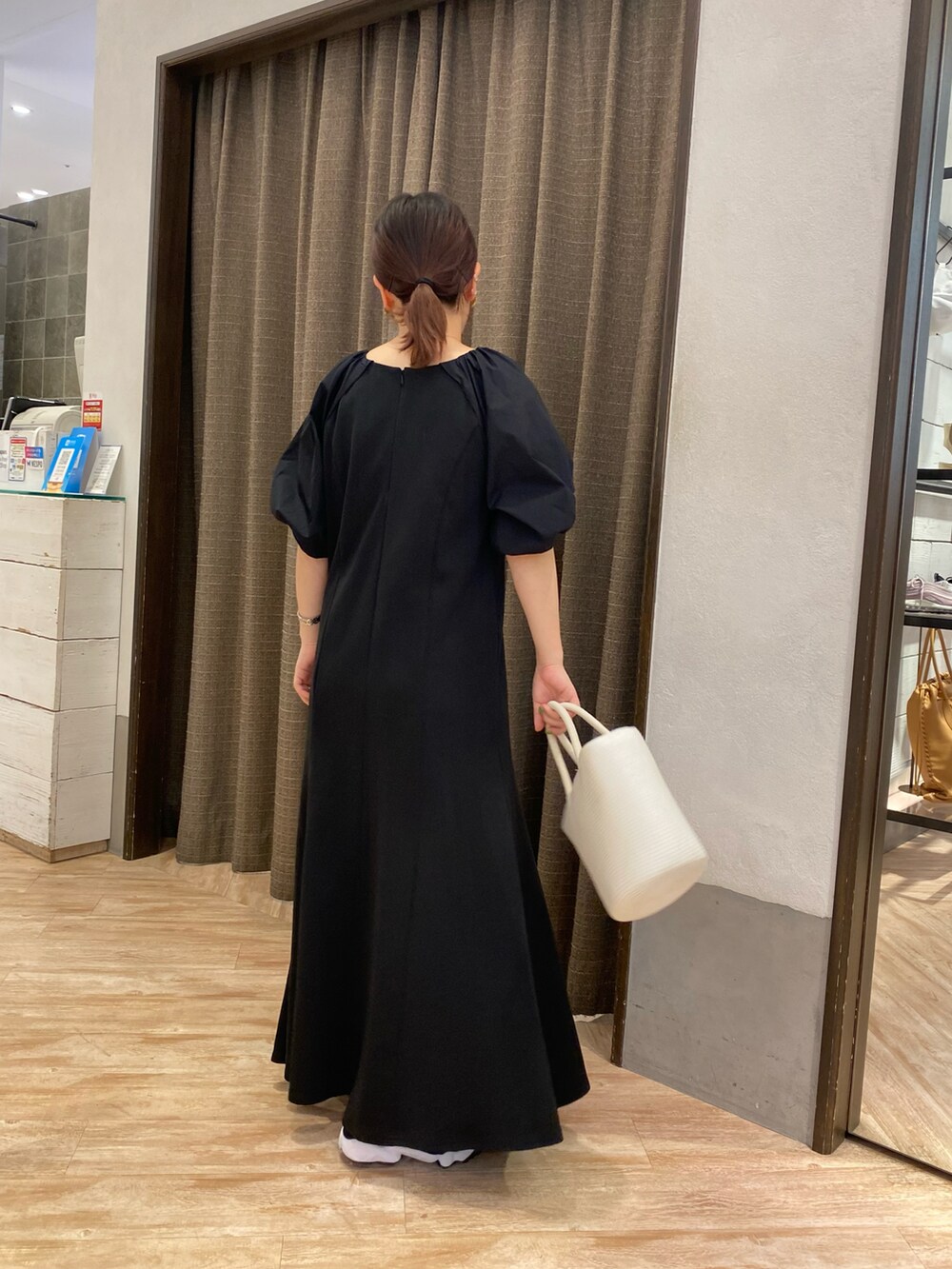 ホワイト系のハンドバッグ、ブラック系のワンピース、ブラック系のその他シューズを着用したレディースの春コーディネートの3枚目の写真