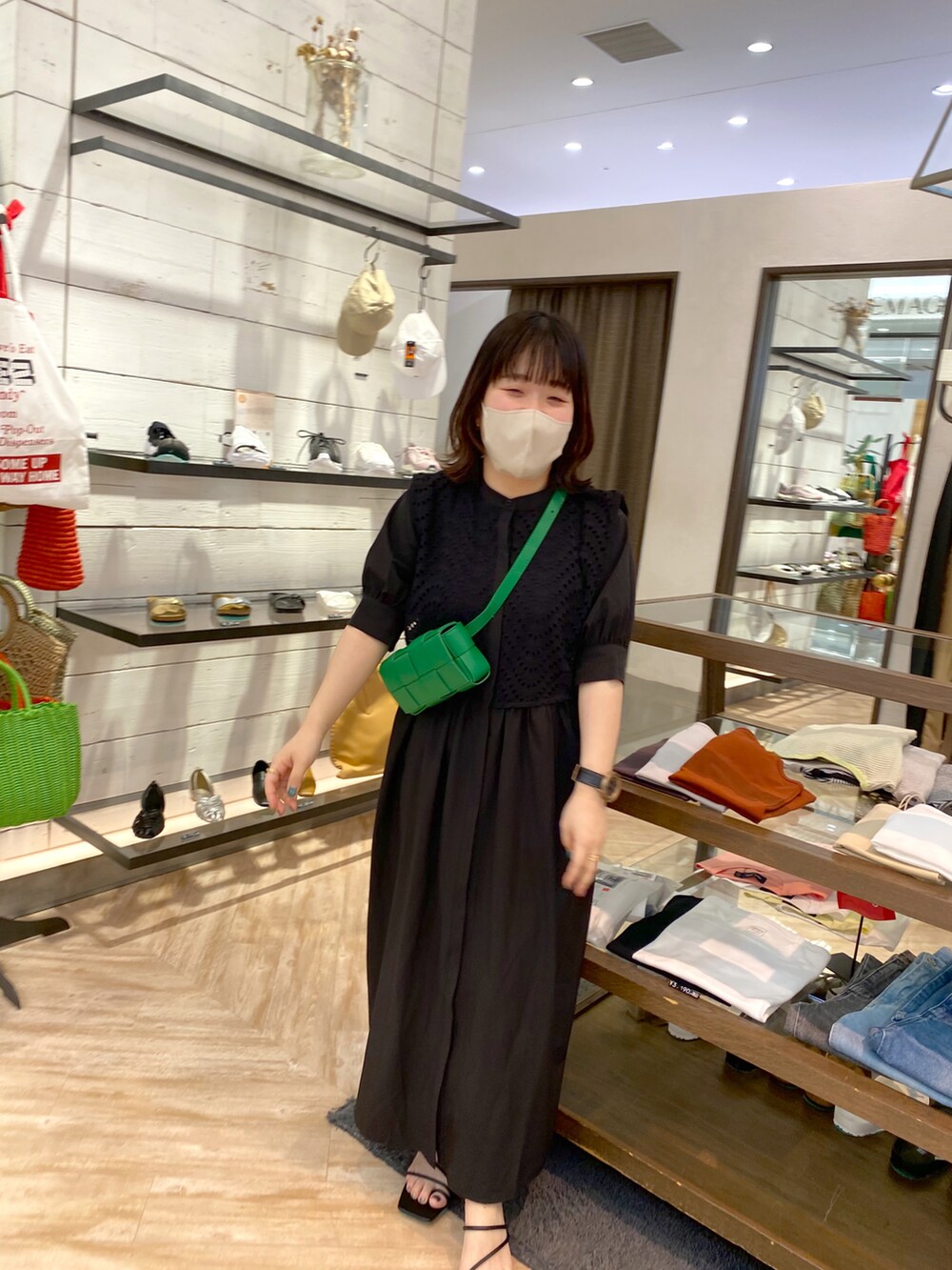 ブラック系のサンダル、ブラック系のワンピース、グリーン系のボディバッグ/ウエストポーチを着用したレディースの夏コーディネートの5枚目の写真