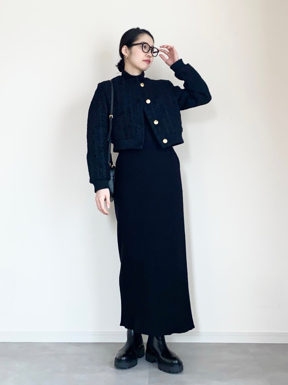 ブラック系のノーカラージャケット、ブラック系のスカート、ブラック系のブーツを着用したレディースの冬コーディネートの3枚目の写真