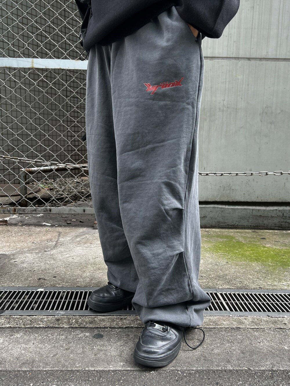 ブラック系のベスト、ブラック系のニット/セーター、グレー系のスウェットパンツを着用したレディースの秋コーディネートの5枚目の写真