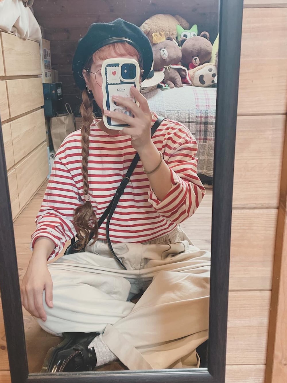 レッド系のTシャツ/カットソー、ブラック系のハンドバッグ、ブラウン系のローファーを着用したレディースの秋コーディネートの3枚目の写真