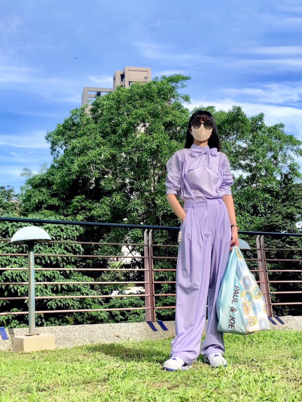 パープル系のシャツ/ブラウス、パープル系のスーツパンツ、ホワイト系のスニーカーを着用したレディースの夏コーディネートの4枚目の写真