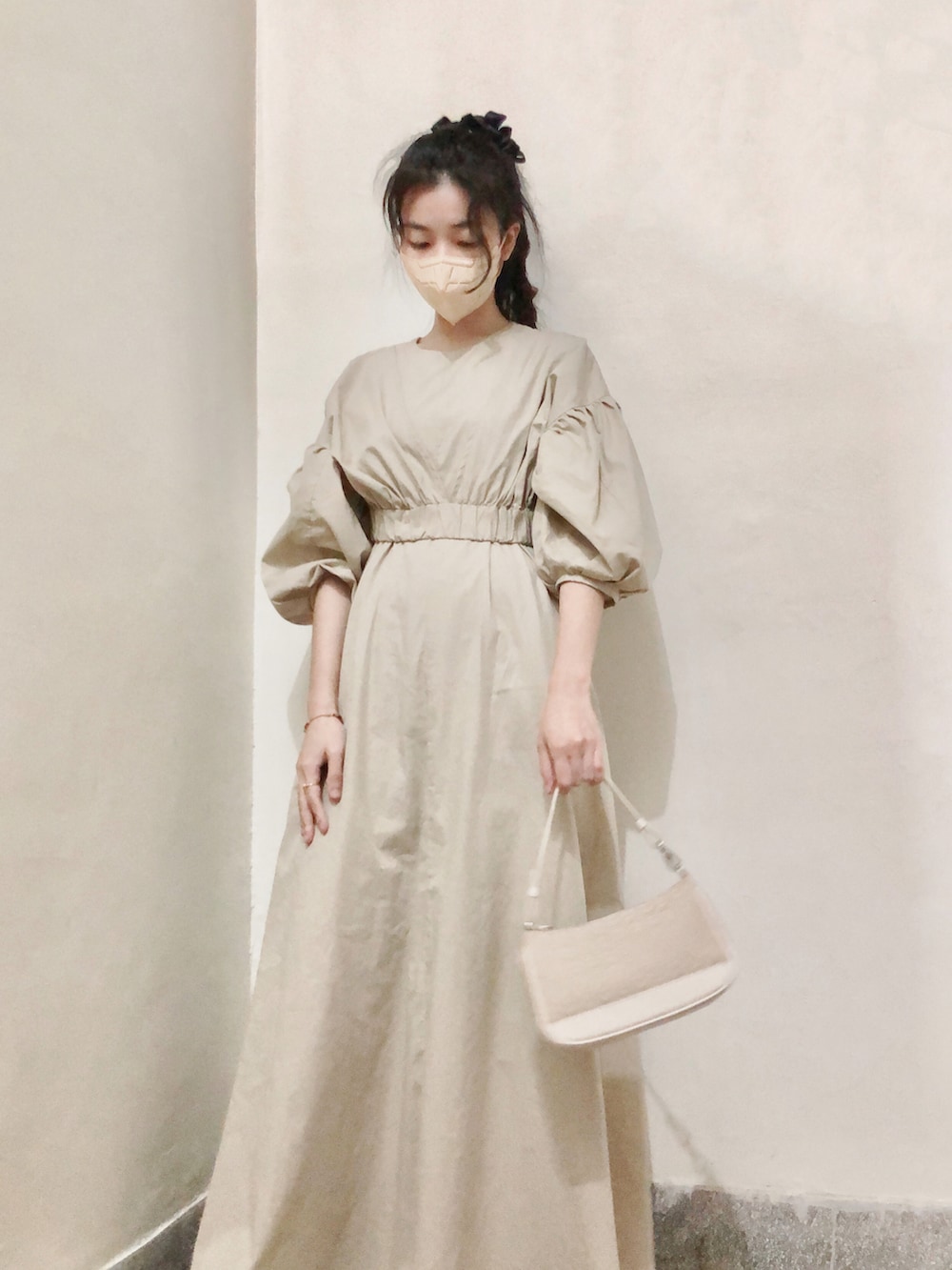 ベージュ系のワンピース、ベージュ系のスニーカー、レッド系のリングを着用したレディースの秋コーディネートの3枚目の写真