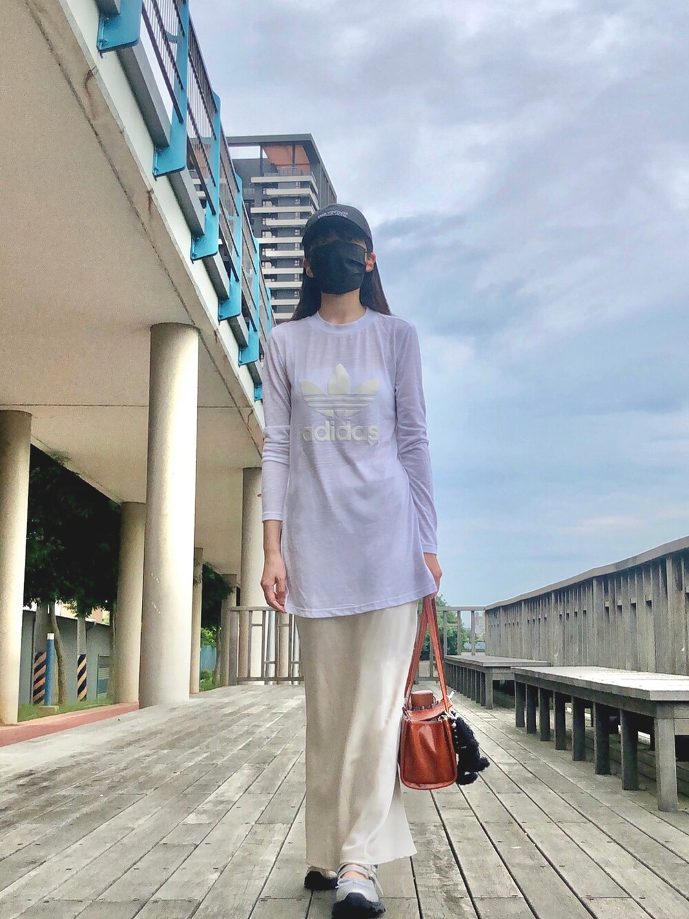 ホワイト系のTシャツ/カットソー、ベージュ系のスカート、その他のショルダーバッグを着用したレディースの春コーディネートの2枚目の写真