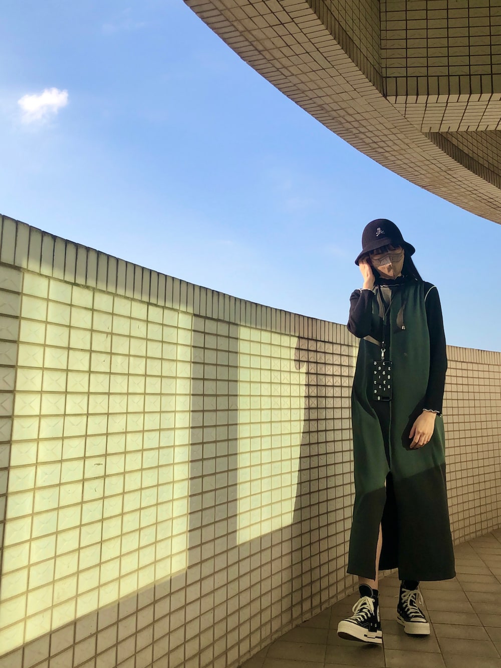 ブラック系のその他トップス、グリーン系のジャンパースカート、ブラック系のジャケット/アウターを着用したレディースの秋コーディネートの2枚目の写真