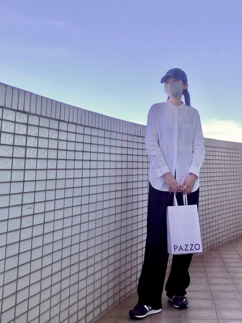 ブルー系のスニーカー、ブラック系のチューブトップ、ブラック系のスーツパンツを着用したレディースの夏コーディネートの2枚目の写真