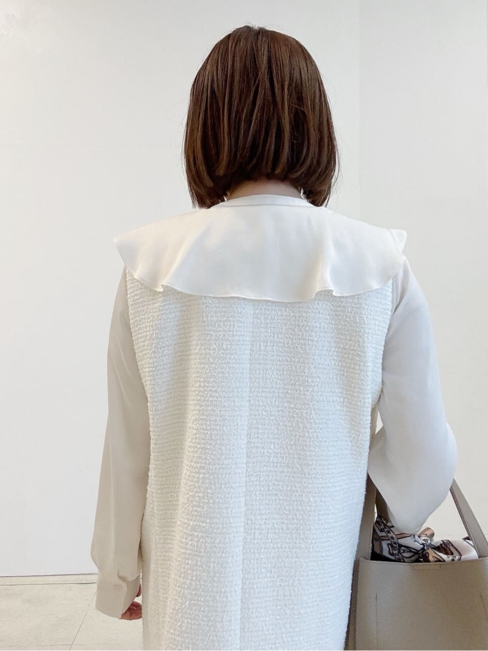 ベージュ系のパンプス、オレンジ系のその他パンツ、ベージュ系のハンドバッグを着用したレディースの春コーディネートの3枚目の写真