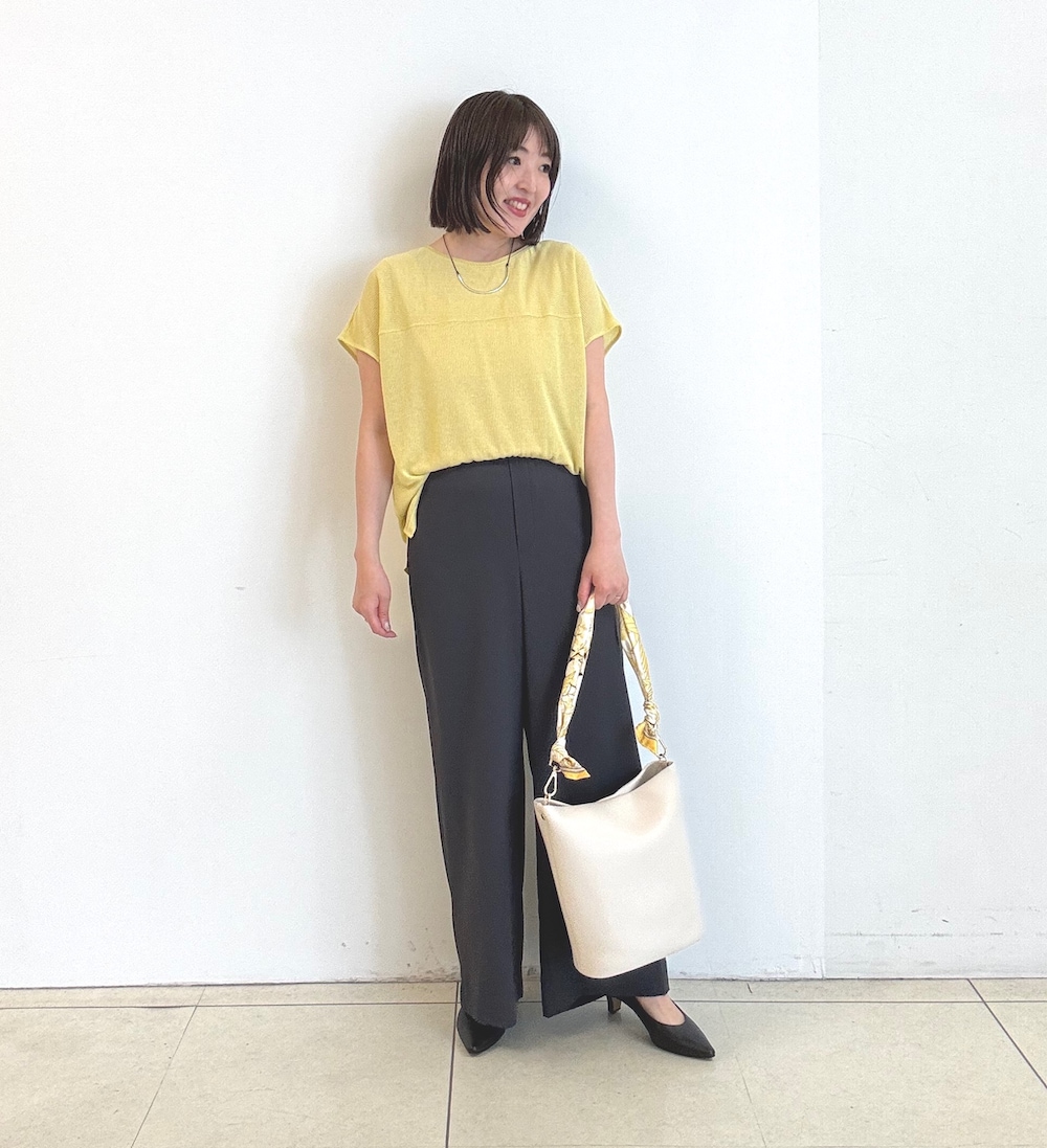 ブラック系のパンプス、イエロー系のTシャツ/カットソー、ホワイト系のハンドバッグを着用したレディースの春コーディネートの2枚目の写真