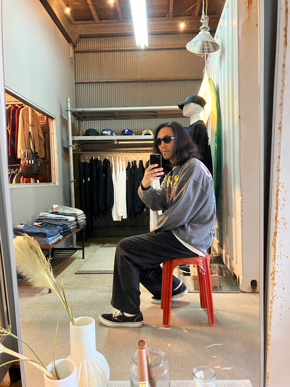 ブラック系のスラックス、グレー系のスウェット、ブラック系のスニーカーを着用したメンズの冬コーディネートの2枚目の写真