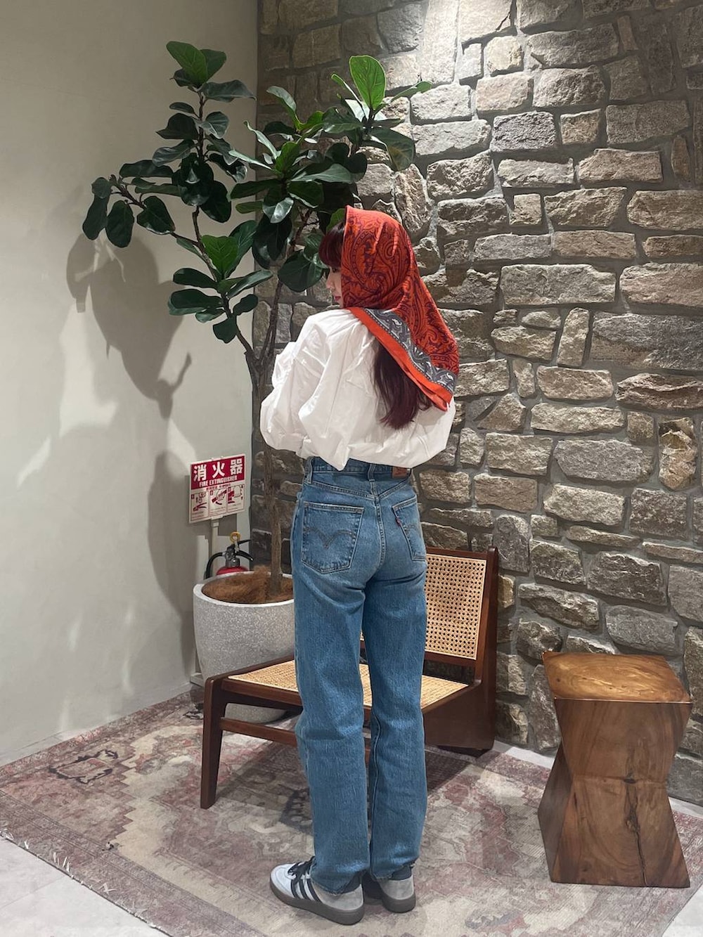 ホワイト系のシャツ/ブラウス、ブルー系のデニムパンツ、グレー系のサングラスを着用したレディースの冬コーディネートの3枚目の写真