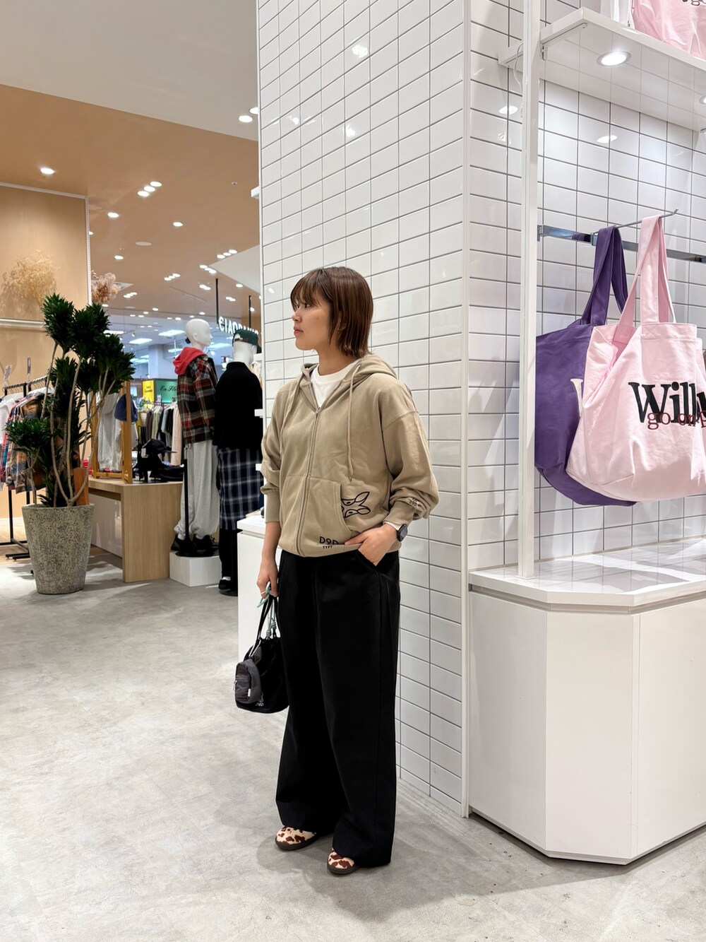 ベージュ系のパーカー、ブラック系のデニムパンツ、ブラック系のトートバッグを着用したレディースの秋コーディネートの3枚目の写真