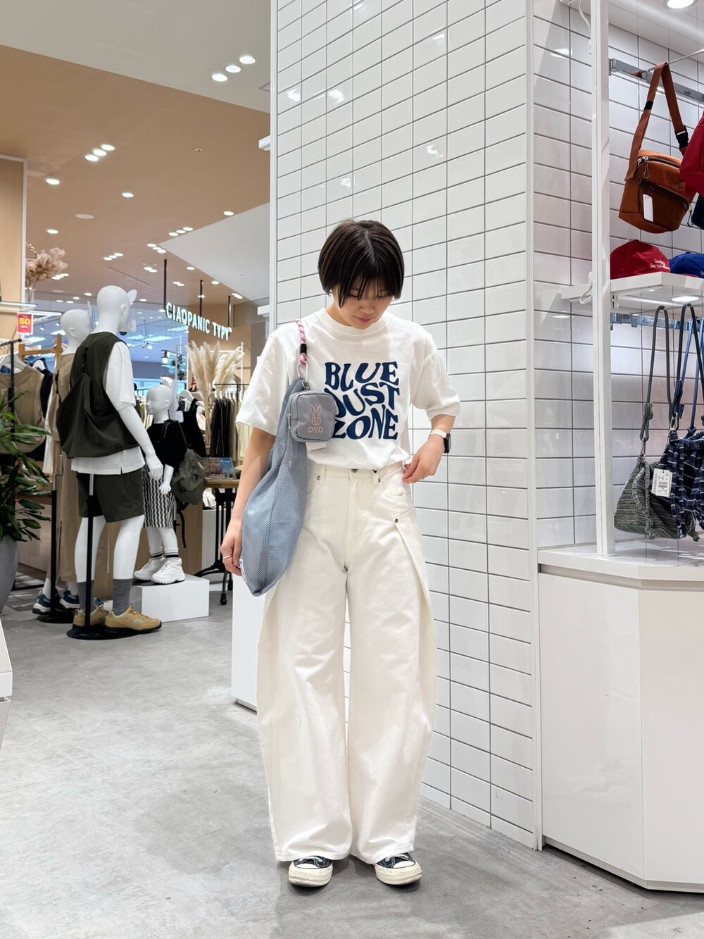 ホワイト系のTシャツ/カットソー、ホワイト系のデニムパンツ、グレー系のトートバッグを着用したレディースの春コーディネートの3枚目の写真