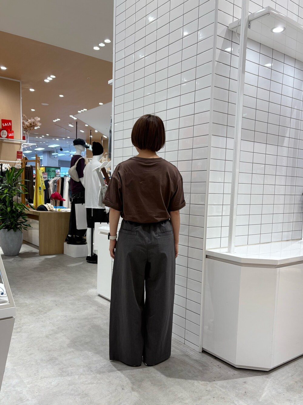 グレー系のデニムパンツ、ブラウン系のTシャツ/カットソーを着用したレディースの秋コーディネートの4枚目の写真