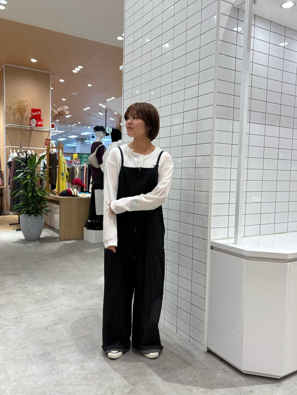 ブラック系のサロペット/オーバーオール、ホワイト系のTシャツ/カットソーを着用したレディースの秋コーディネートの2枚目の写真