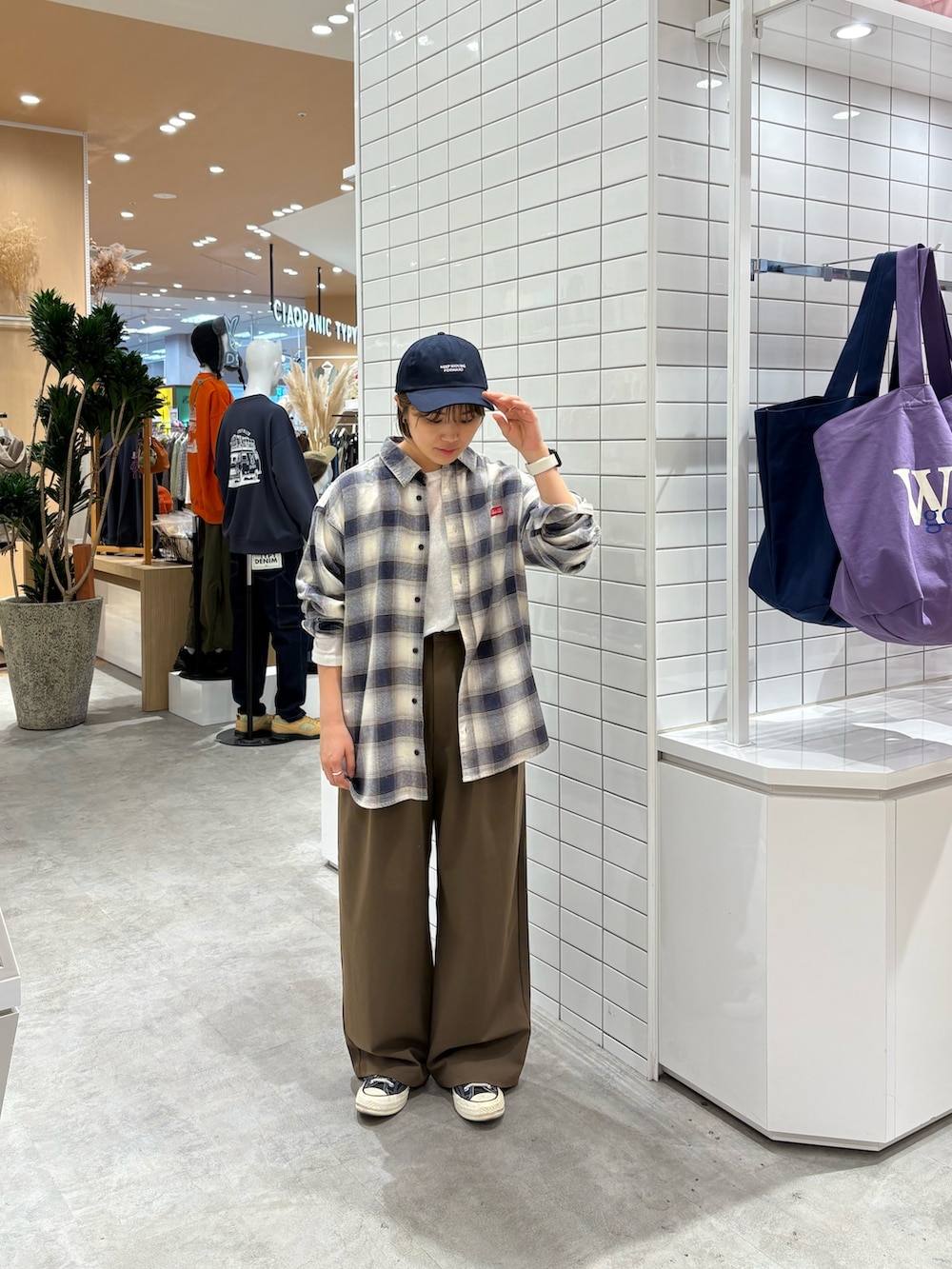 ブラウン系のスラックス、ホワイト系のシャツ/ブラウス、ホワイト系のTシャツ/カットソーを着用したレディースの秋コーディネートの2枚目の写真