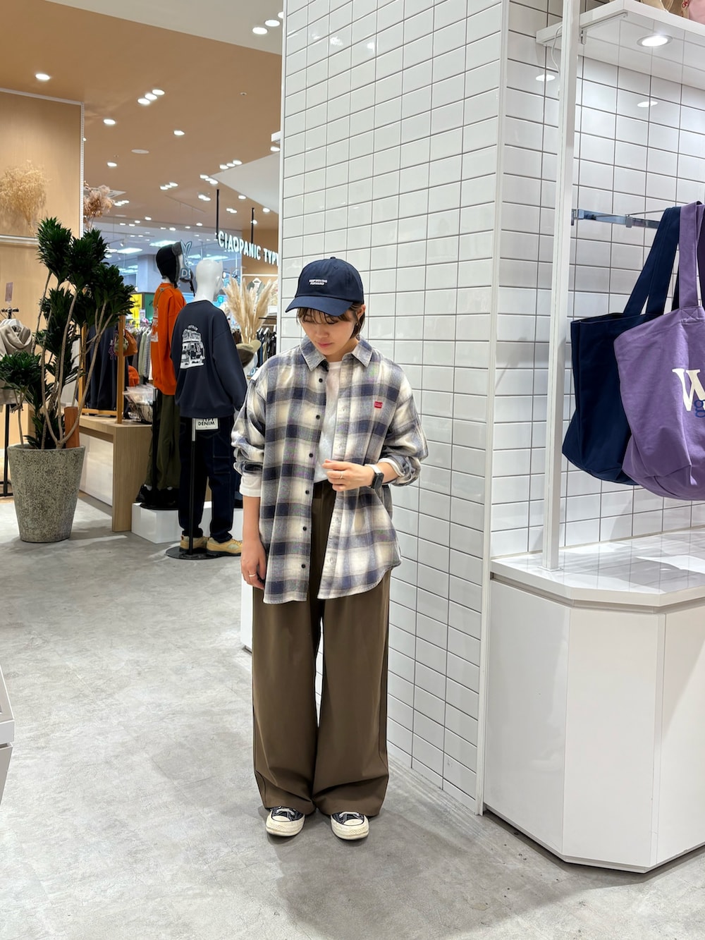 ブラウン系のスラックス、ホワイト系のシャツ/ブラウス、ホワイト系のTシャツ/カットソーを着用したレディースの秋コーディネートの3枚目の写真