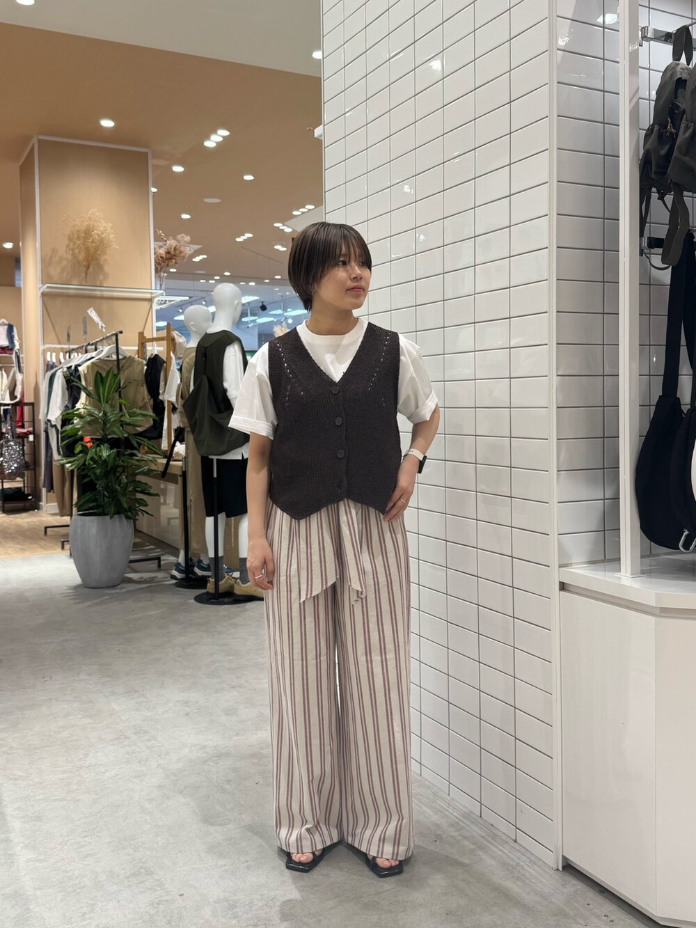 ブラウン系のベスト、ホワイト系のその他パンツ、ホワイト系のTシャツ/カットソーを着用したレディースの夏コーディネートの2枚目の写真