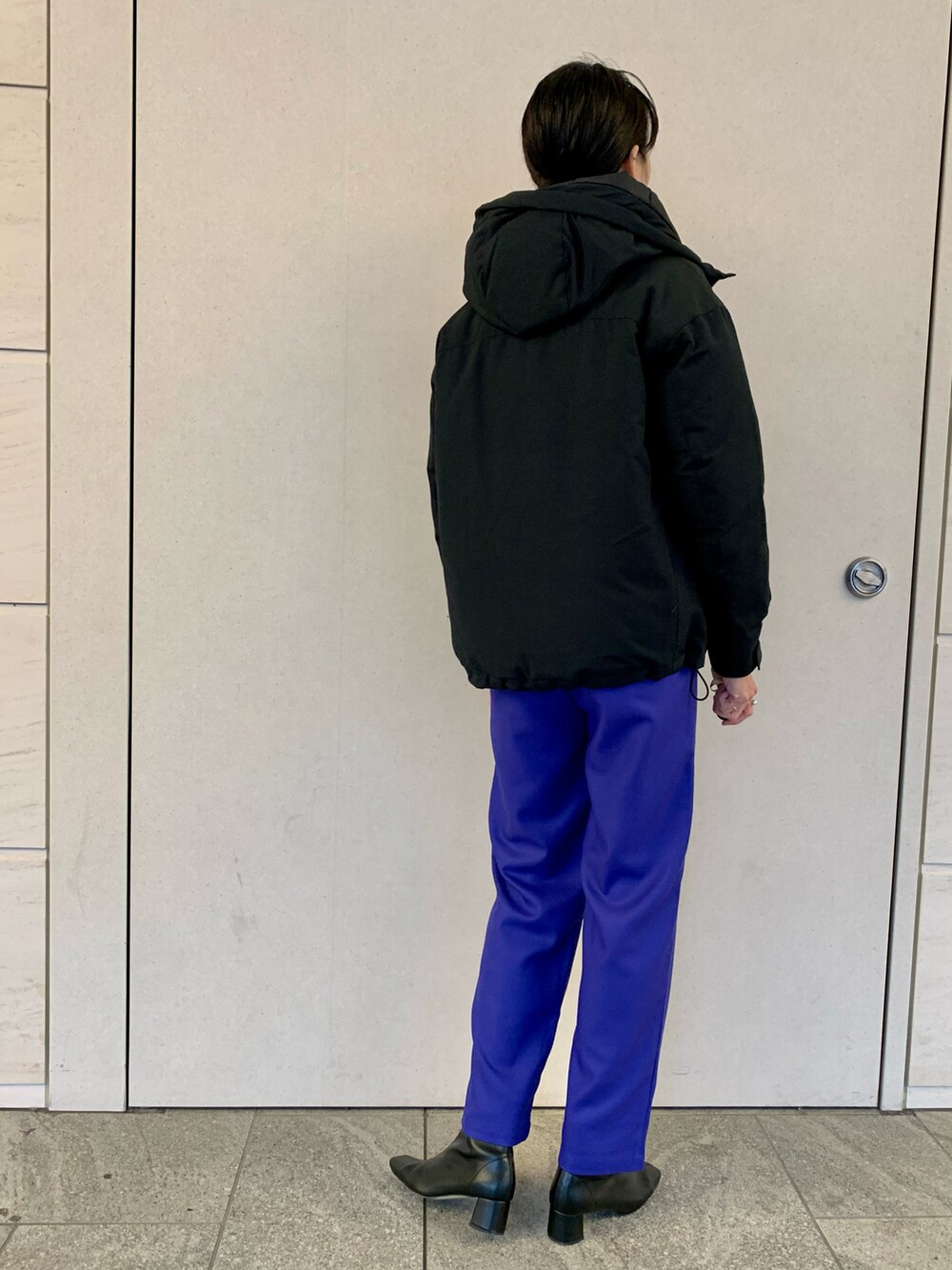 ブラック系のダウンジャケット/コート、グレー系のニット/セーター、ブルー系のその他パンツを着用したレディースの冬コーディネートの3枚目の写真