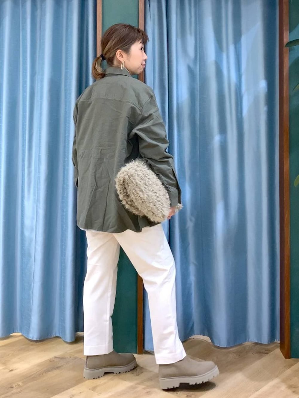 ベージュ系のハンドバッグ、ベージュ系のブーツ、ホワイト系のTシャツ/カットソーを着用したレディースの冬コーディネートの4枚目の写真